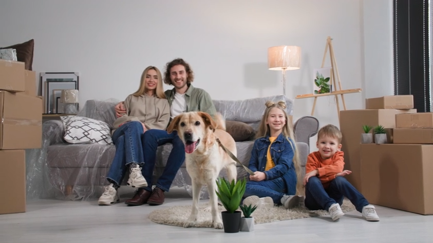 Family sitting at home with their dog